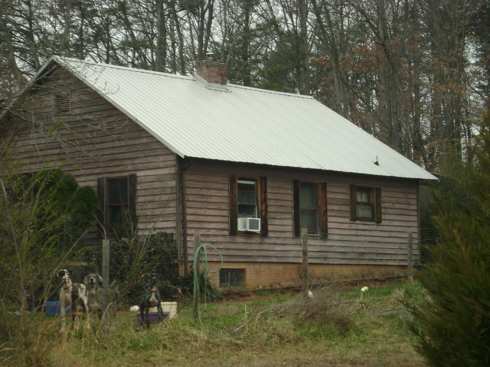White metal roof on an old wood sided farmhouse, from a Metal Roof Installation job in Montvale